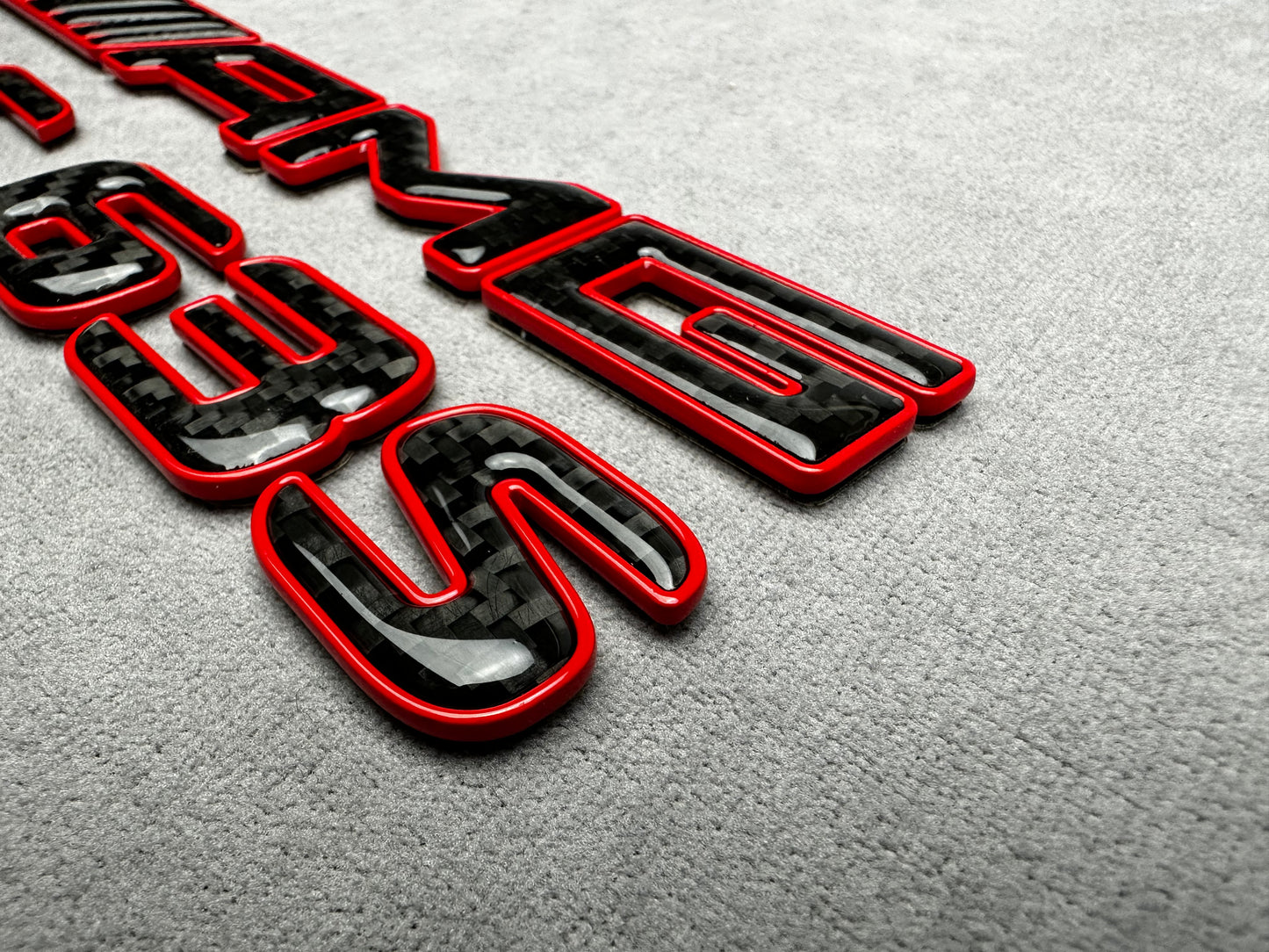 AMG C 63 S red metal with carbon emblem badge for Mercedes C-Class (W204, W205, W206), exterior styling upgrade