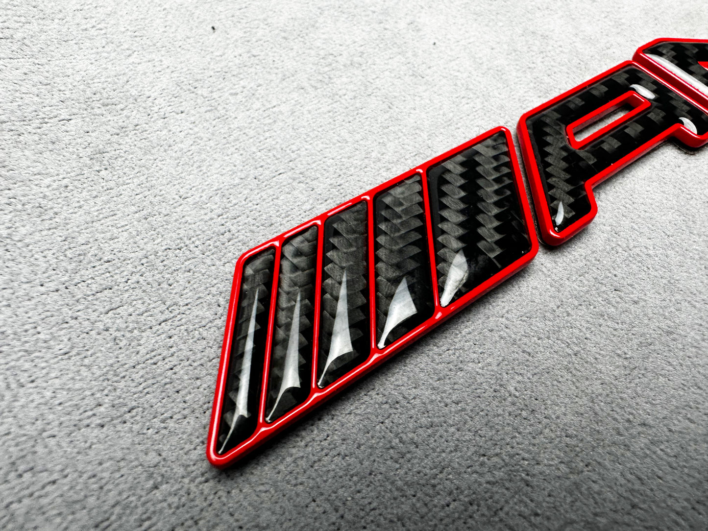 AMG G63 red metallic with carbon emblem badge for Mercedes G-Class W465, premium finish, easy installation