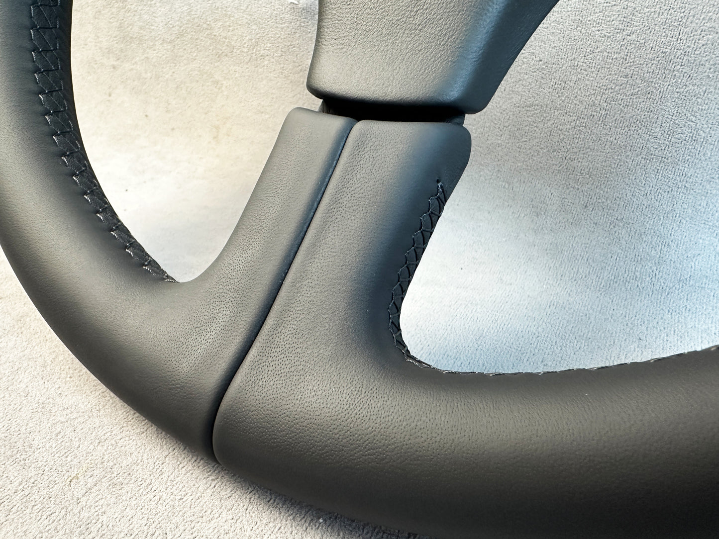 Classic three-spoke Atiwe steering wheel on white background