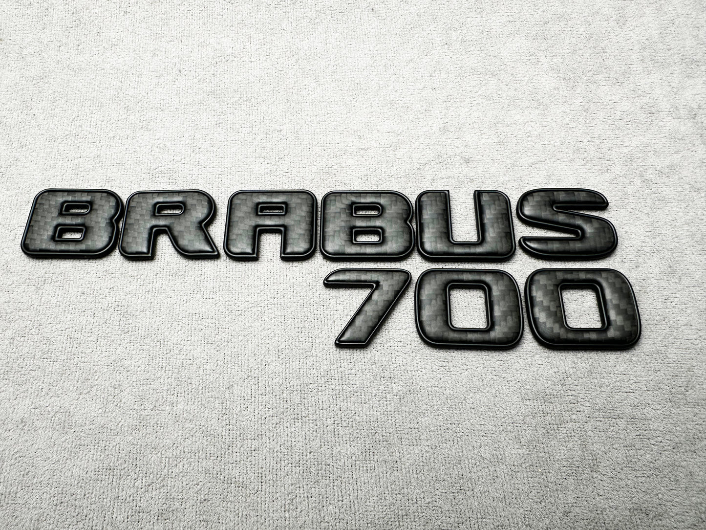 Brabus 700 carbon matte with metal trunk badge emblem for Mercedes, sleek and durable design for high-performance vehicles