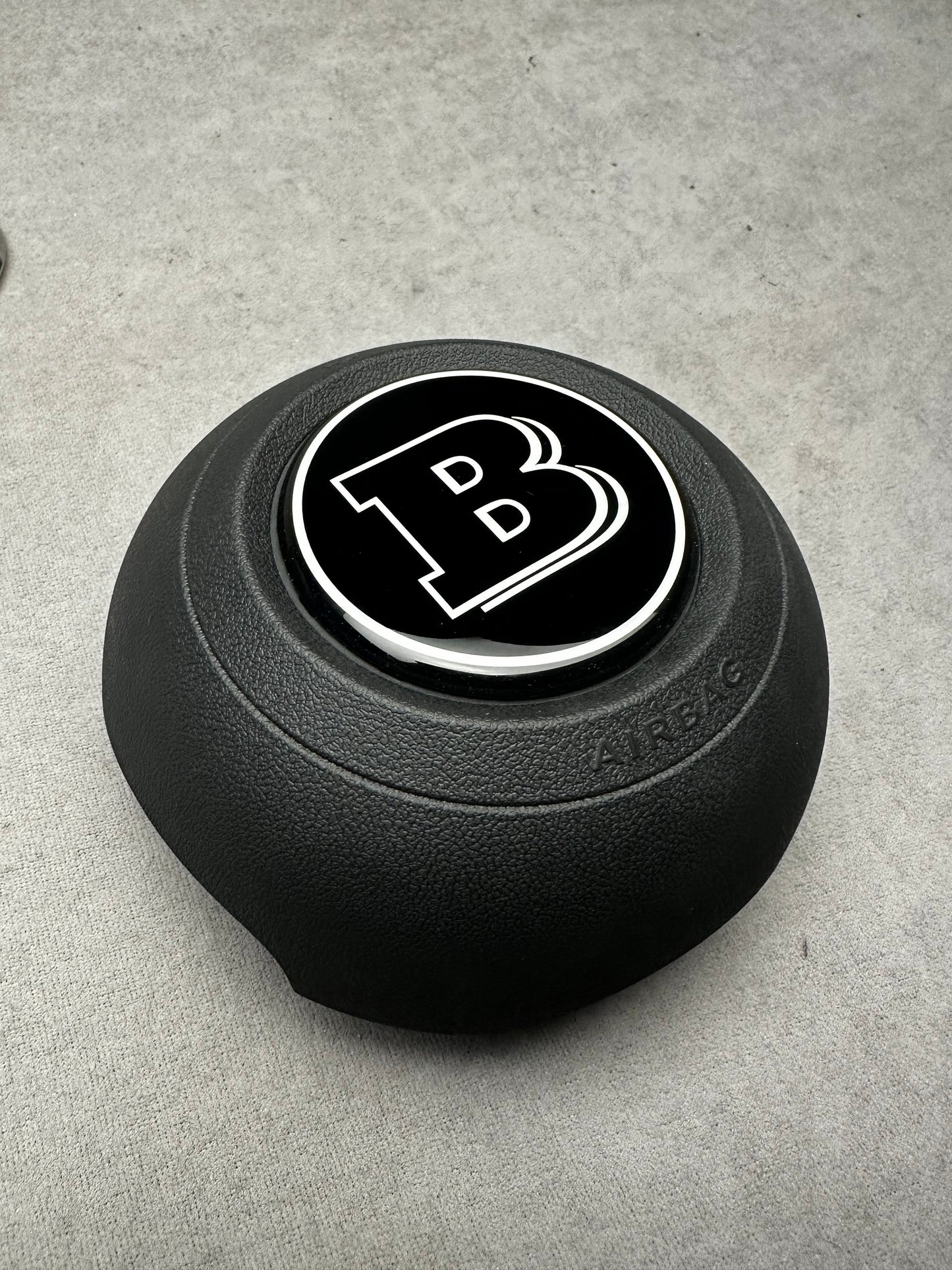 Brabus black emblem for airbag steering wheel, compatible with 2024+ Mercedes G-W465, S-W223, GLE, GLS models, sleek modern design