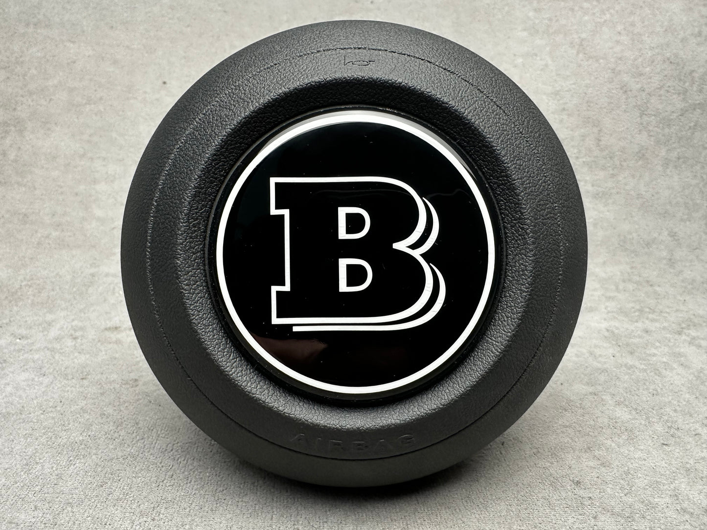 Brabus black emblem for airbag steering wheel, compatible with 2024+ Mercedes G-W465, S-W223, GLE, GLS models, sleek modern design