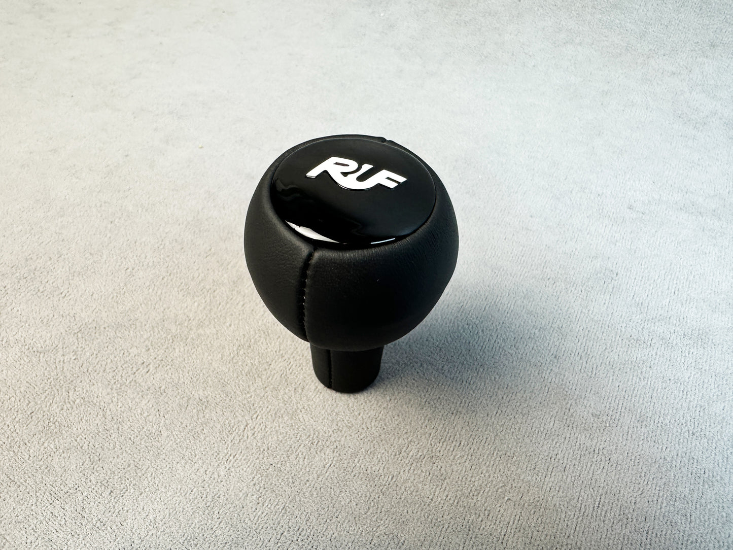 Close-up of RUF gloss plastic logo on leather knob