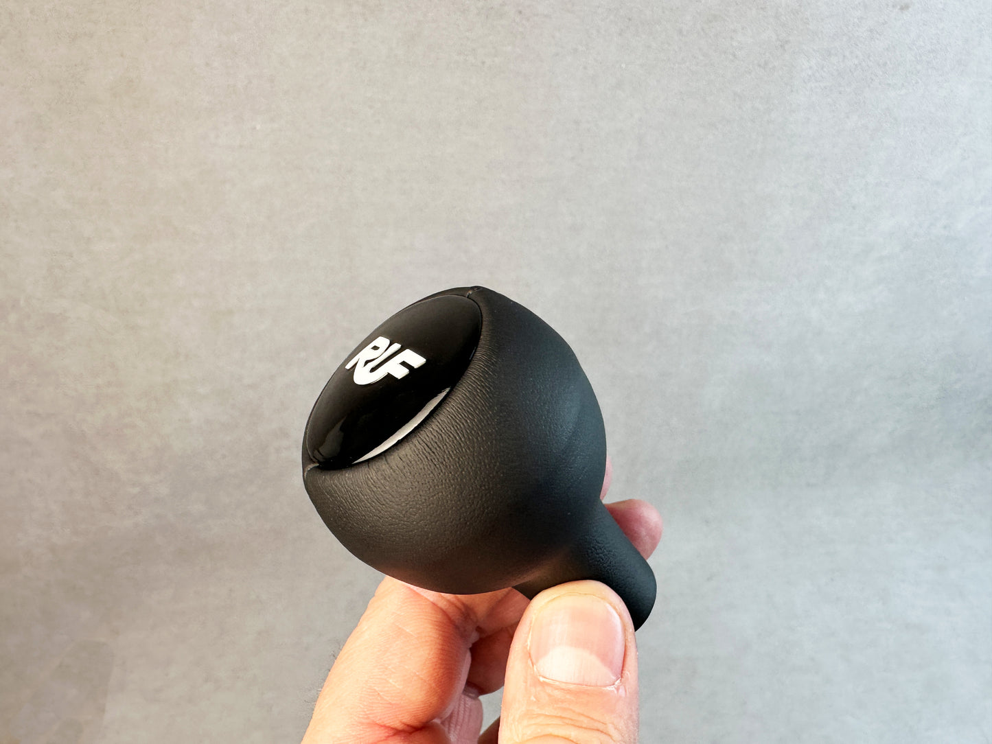 Close-up of RUF gloss plastic logo on leather knob