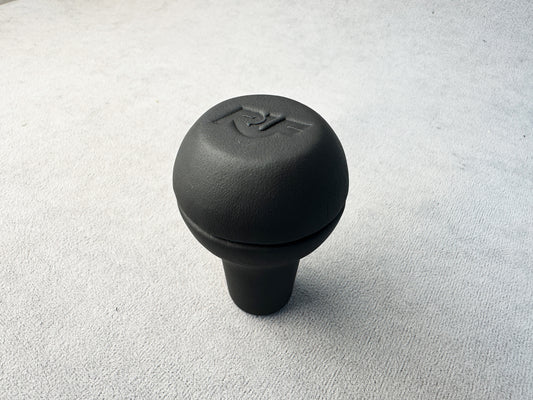 Close-up of RUF logo on black leather shift knob