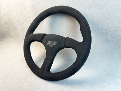 Close-up of grey stitching on Alcantara RUF steering wheel