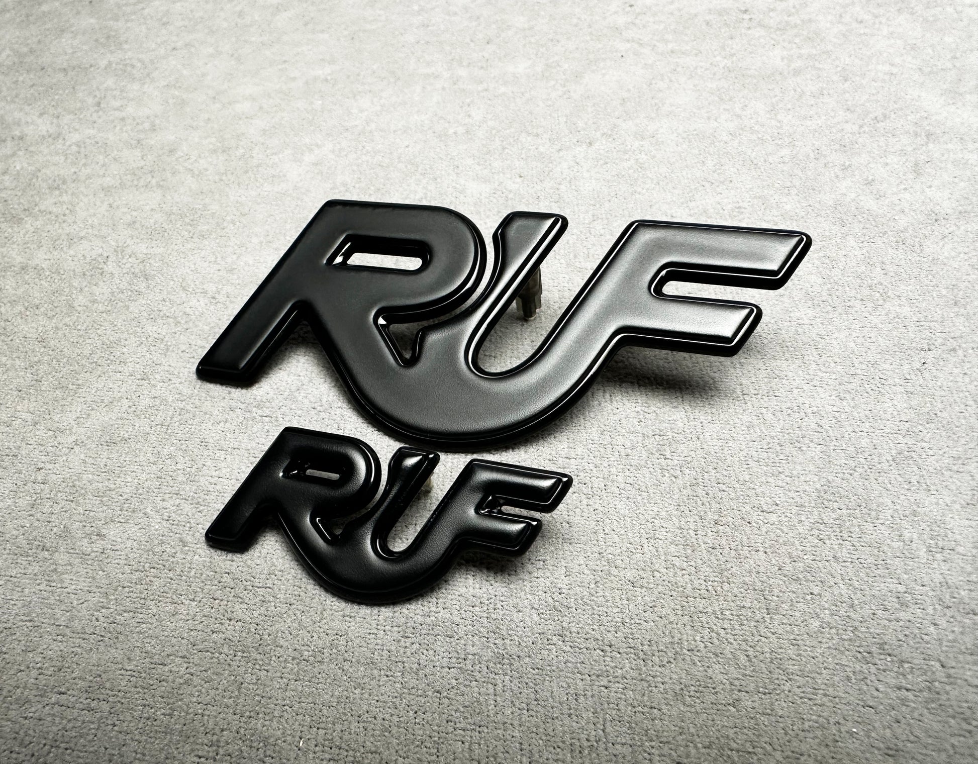 Close-up of black metal RUF badge for Porsche classic models