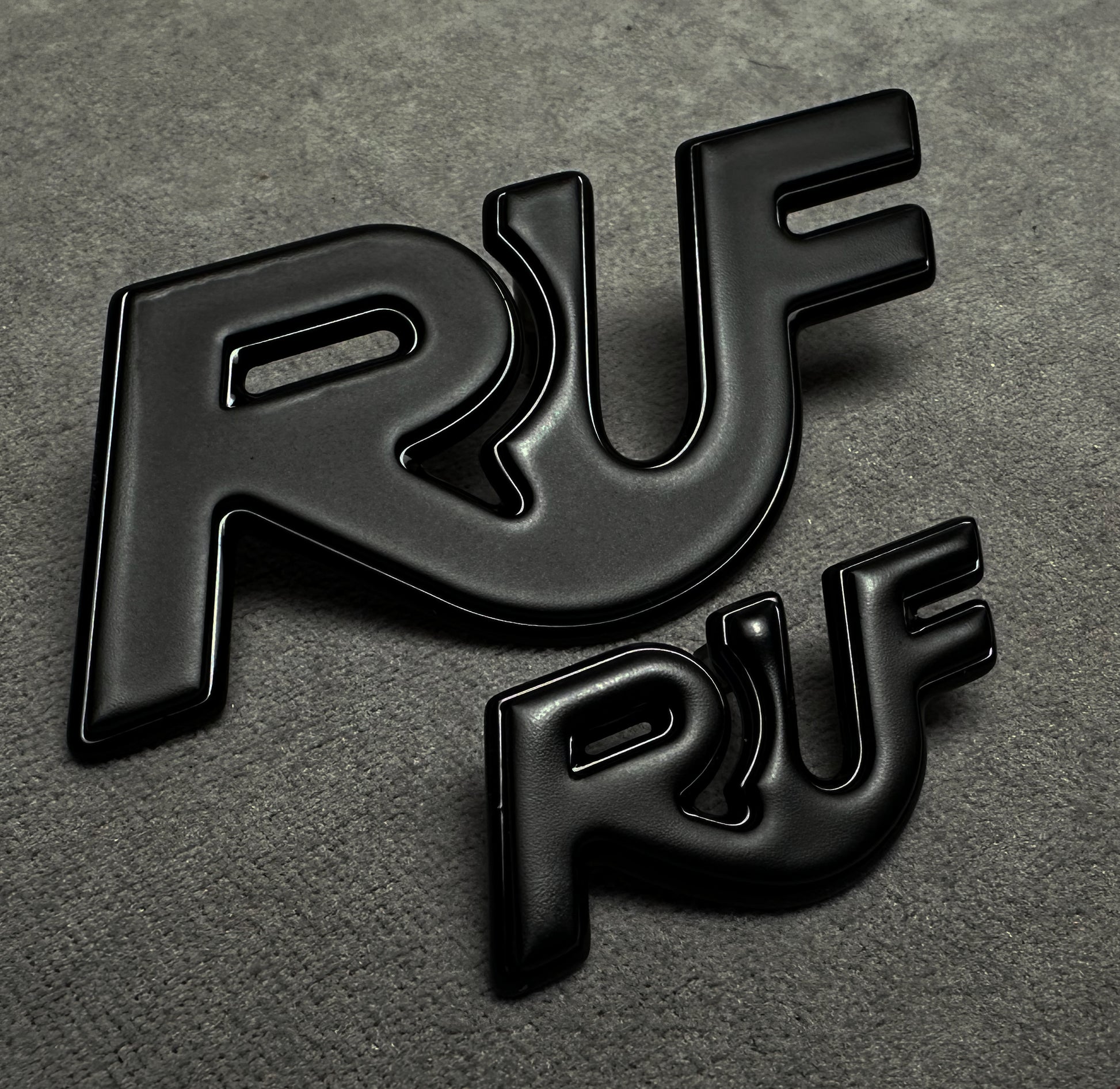 Porsche 997 with installed black RUF metal emblem for performance styling