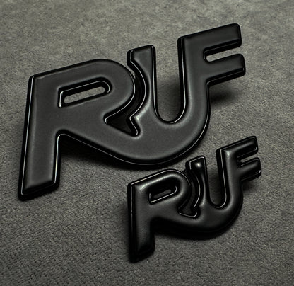 Porsche 997 with installed black RUF metal emblem for performance styling