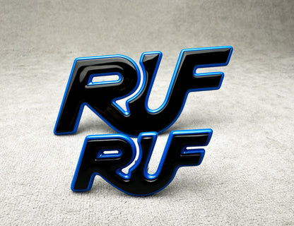 Porsche 997 with installed black and blue RUF metal emblem for performance styling