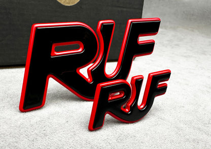 Porsche 997 with installed black and red RUF metal emblem for performance styling