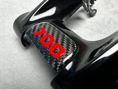 Close-up of Brabus 700 flat carbon interior emblem on a Mercedes steering wheel