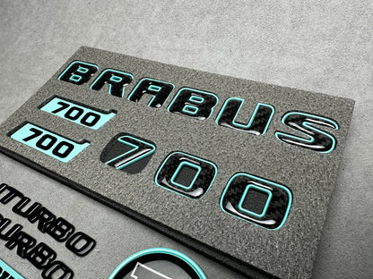Brabus 700 Tiffany Blue with Carbon exterior emblems set for G-Wagon W463A W465, including trunk, Biturbo side badges, round B for hood, and Brabus insertions