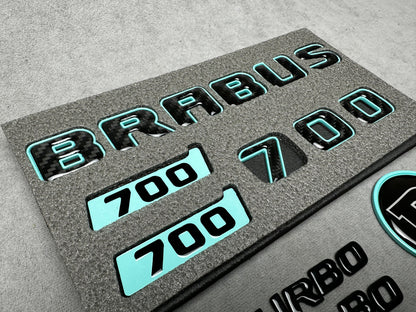 Brabus 700 Tiffany Blue with Carbon exterior emblems set for G-Wagon W463A W465, including trunk, Biturbo side badges, round B for hood, and Brabus insertions