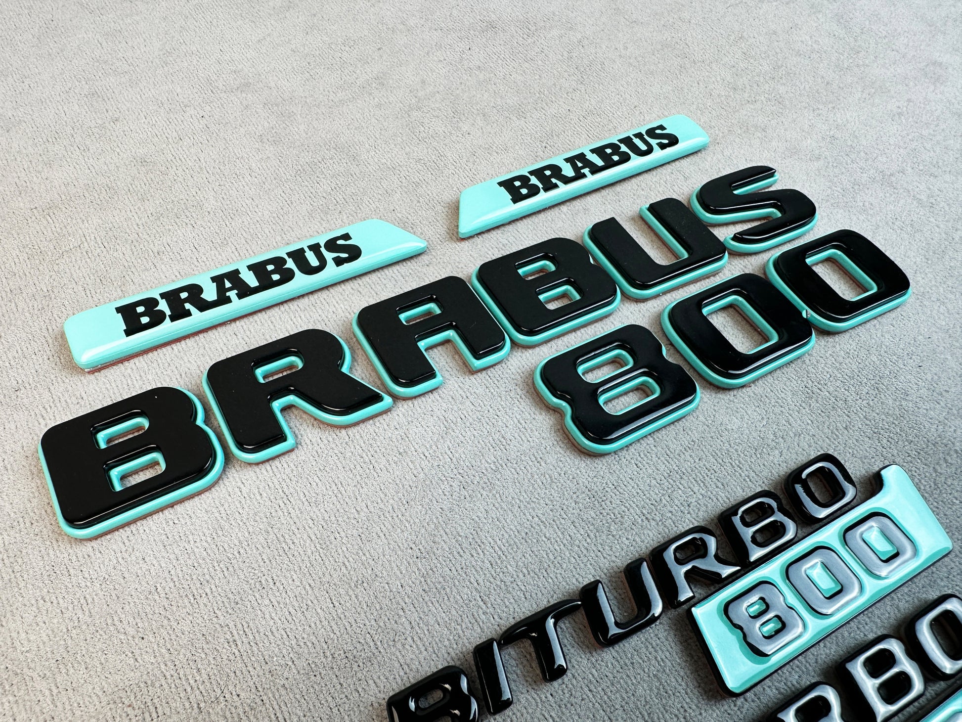 Complete badge kit laid out for Mercedes G-Class W463A