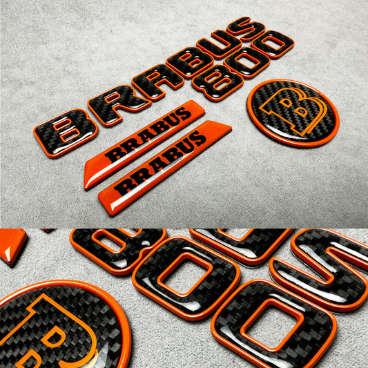 Brabus 800 orange metallic emblem badge with carbon fiber accents for Mercedes G-Wagon W463A, premium exterior upgrade
