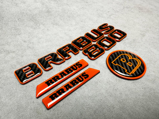 Brabus 800 orange metallic emblem badge with carbon fiber accents for Mercedes G-Wagon W463A, premium exterior upgrade