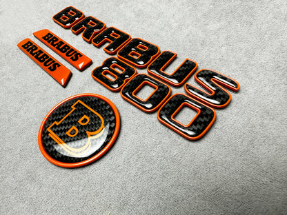 Brabus 800 orange metallic emblem badge with carbon fiber accents for Mercedes G-Wagon W463A, premium exterior upgrade