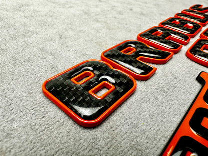 Brabus 900 Orange Metal and Carbon Emblem Set for Mercedes GT – Full badge set featuring premium metallic orange and carbon fiber finish