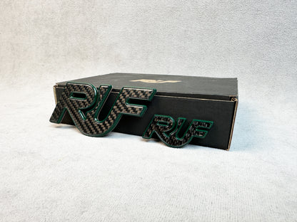 Set of two RUF badges in carbon and green metal for classic Porsche 930