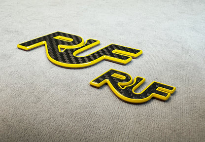 Detailed texture of carbon and yellow metal RUF emblem