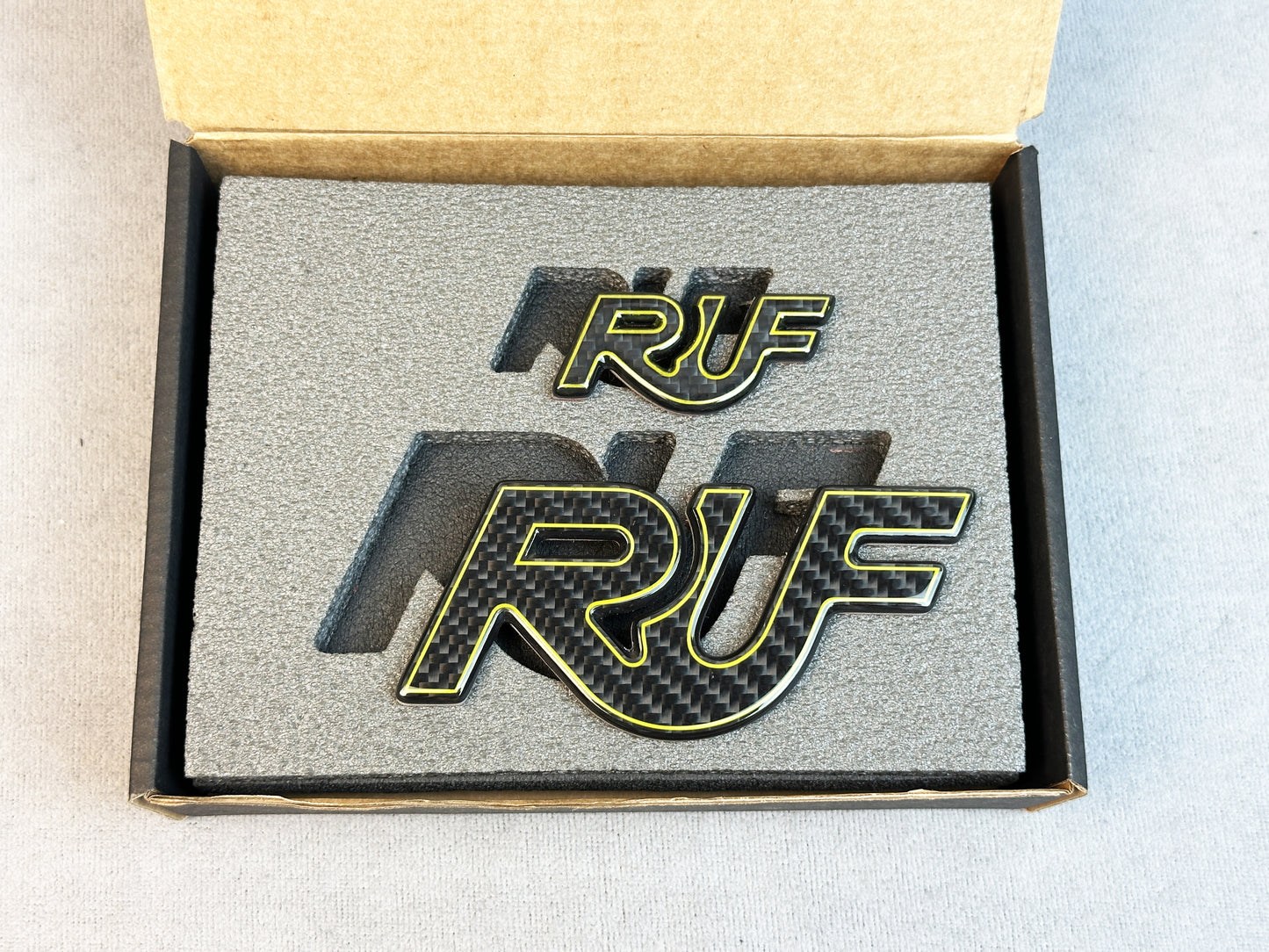 Close-up of RUF emblem with carbon and yellow details