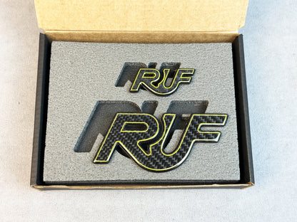 Close-up of RUF emblem with carbon and yellow details