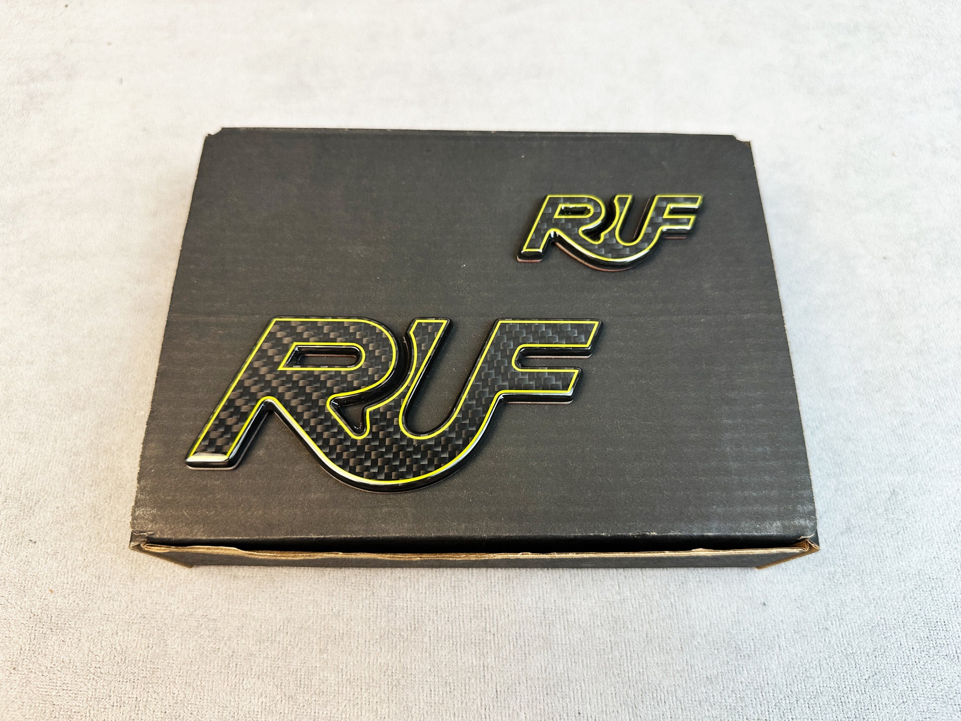 Twin badge set of RUF yellow outline emblems displayed