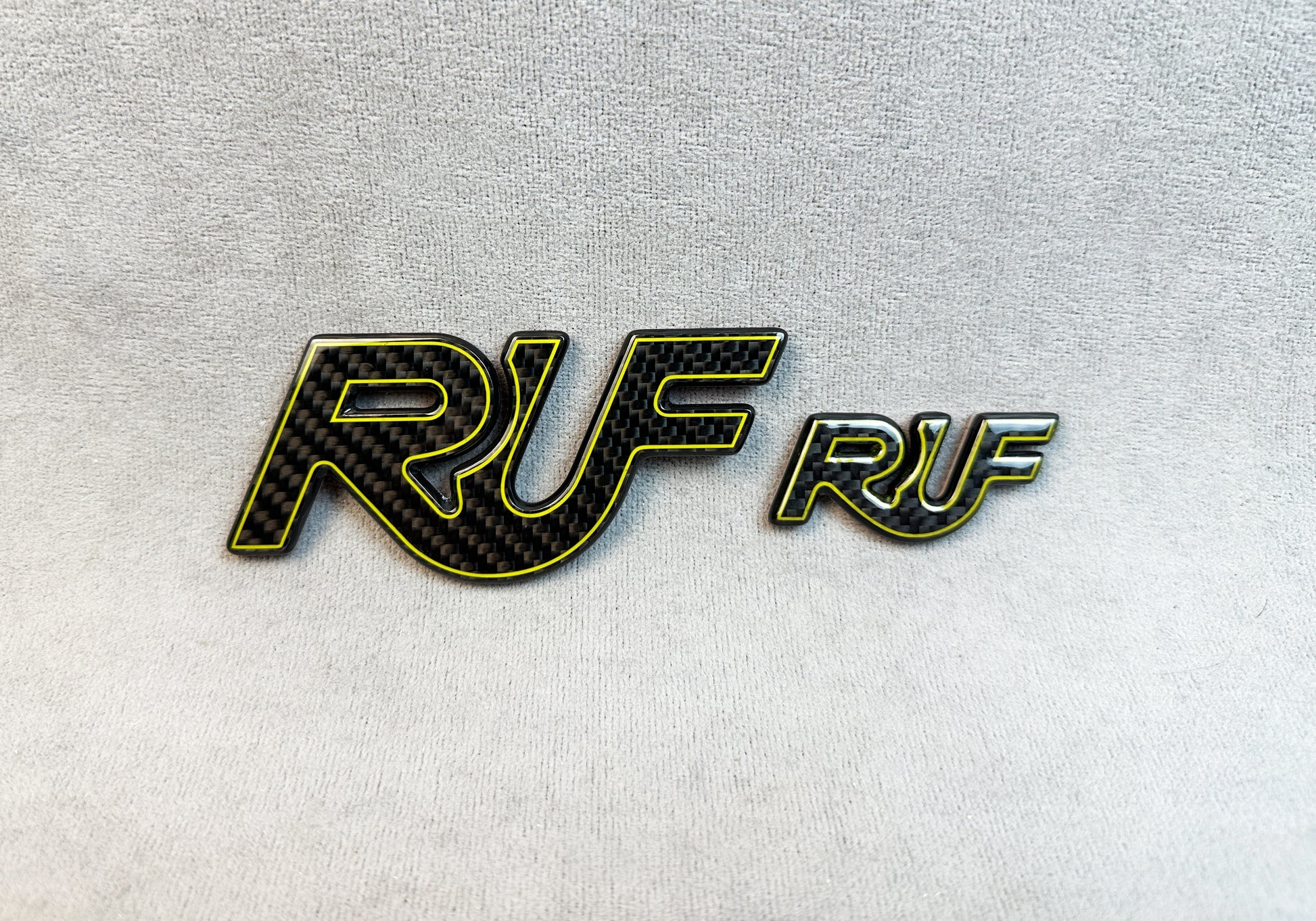 Motorsport styling with yellow-outline RUF emblem