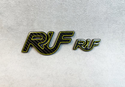 Motorsport styling with yellow-outline RUF emblem