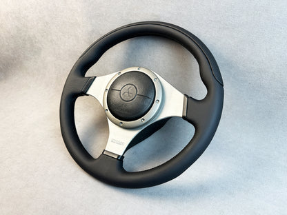 Close-up of black leather and red stitching on Evo MOMO wheel