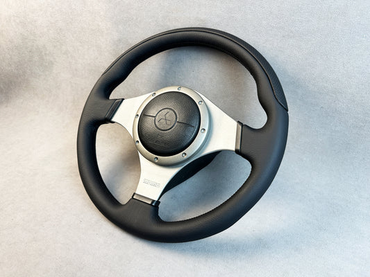 Close-up of black leather and red stitching on Evo MOMO wheel