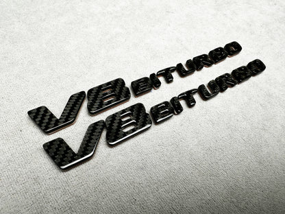 Close-up of V8 Biturbo carbon fender badge on Mercedes AMG